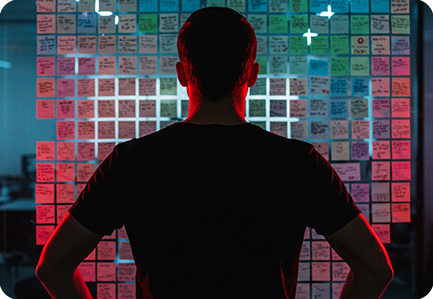 HomePage-HumanIntelligence Men standing in front of AI screen